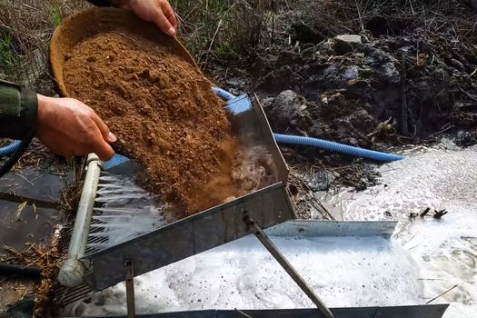 Washing the rock containing gold. Search and extraction of gold.