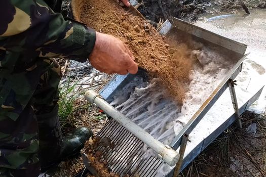 Washing the rock containing gold. Search and extraction of gold.