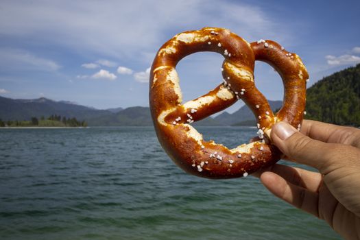 hand holding a pretzel at Walchensee