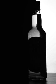 A bottle of whiskey on a black and white background. Optical effect. High quality photo