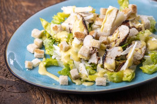 caesar salad on a blue plate