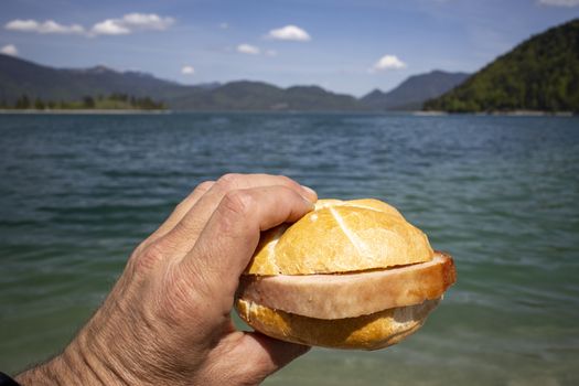 hand holding a meat loaf bun at Walchensee