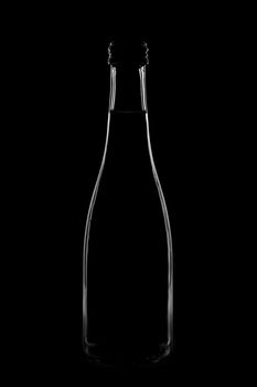 Silhouette of a bottle with a beautiful shape on a black background. High quality photo