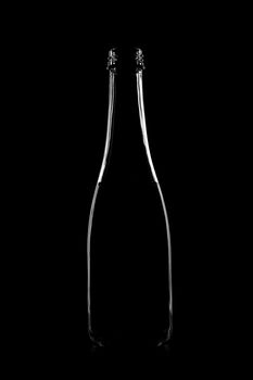 Silhouette of a bottle with a beautiful shape on a black background. High quality photo