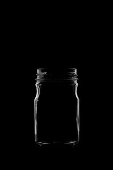 Silhouette of a bottle with a beautiful shape on a black background. High quality photo