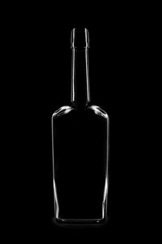 Silhouette of a bottle with a beautiful shape on a black background. High quality photo
