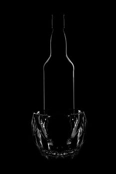 silhouette of a whiskey bottle with a whiskey glass. beautiful shape on a black background. High quality photosilhouette of a whiskey bottle with a whiskey glass. beautiful shape on a black background. 