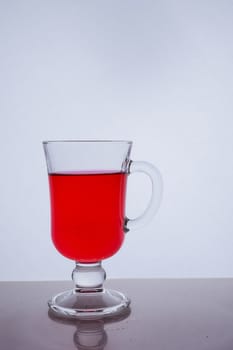 red liquid into a glass on a white background light effect Very high quality photo