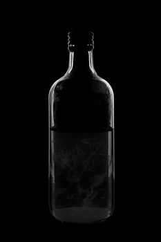 Silhouette of a bottle with a beautiful shape on a black background. High quality photo