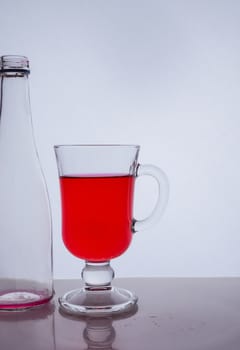 red liquid into a glass on a white background light effect Very high quality photo