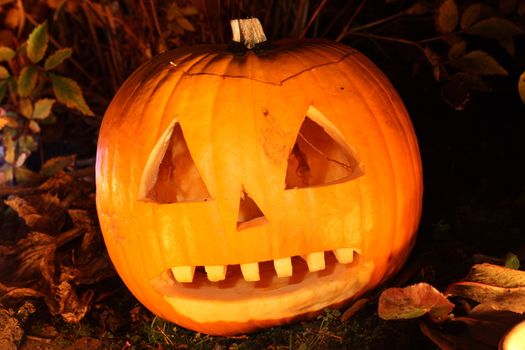 Illuminated spooky Halloween Jack O' Lantern pumpkin in October stock photo