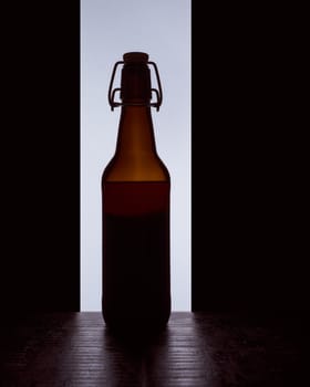 colored silhouette of a beer bottle with a cork on a black white background. Hight quality photo