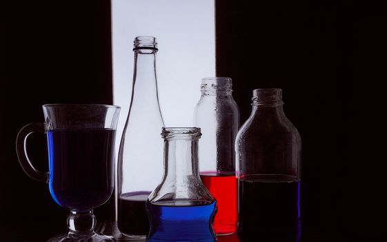 bottled on a light background with blue liquid.silhouette photo. Hight quality photo