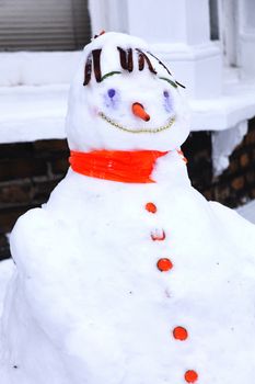 Snowman with a carrot nose and a huge fun smile in the winter season snow stock photo