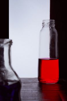 bottled on a light background with blue liquid.silhouette photo. Hight quality photo