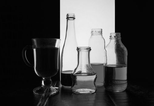 bottled on a light background with liquid black and white silhouette photo. Hight quality photo