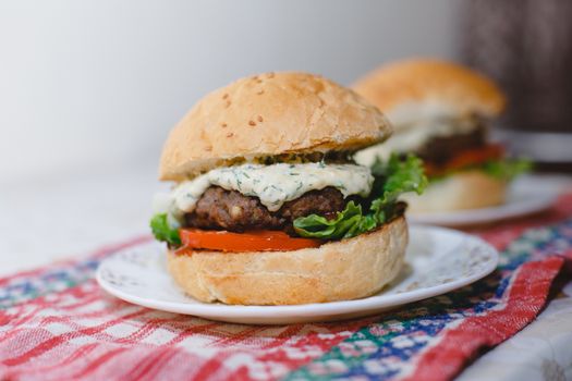 Small homemade burgers lie on a plate. juicy photo with blur closeup photo