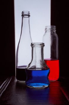 bottled on a light background with blue liquid.silhouette photo. Hight quality photo