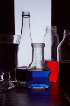 bottled on a light background with blue liquid.silhouette photo. Hight quality photo