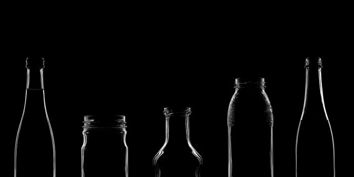 The silhouettes of bottles with various beautiful shapes on a black background. Banner for advertising with a place to insert text. High quality photo