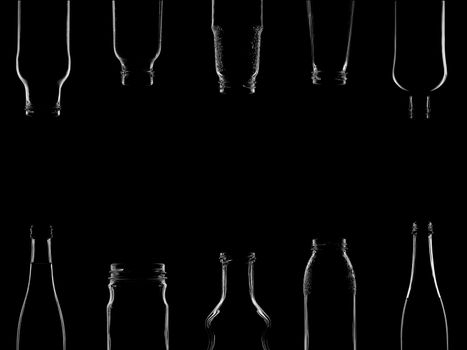 The silhouettes of bottles with various beautiful shapes on a black background. Banner for advertising with a place to insert text. High quality photo