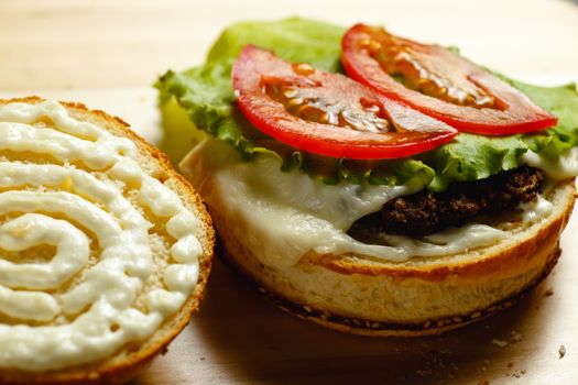 Juicy tomatoes lie on a burger bun closeup photo