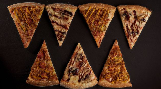 sliced slices of pizza on a sulphurous background in the shape of mountains closeup photo