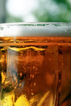 Mug of beer with foam closeup as background