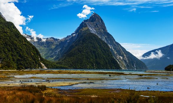 Famous Mitre Peak rising from the Milford Sound fiord at low tide. Fiordland national park, New Zealand