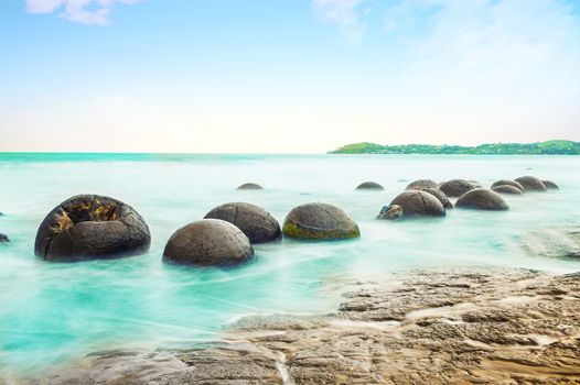 Spheric Moeraki Boulders on the Koekohe beach, Eastern coast of New Zealand.  Long time exposure - see is blurred