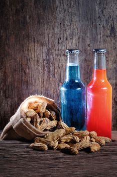 Peanuts and beer on wood background