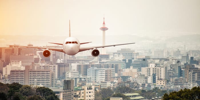 Airplane frying over the kyoto tower background