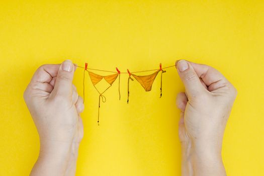 Bikini on the rope. Creative photo for the holiday Bikini Day.