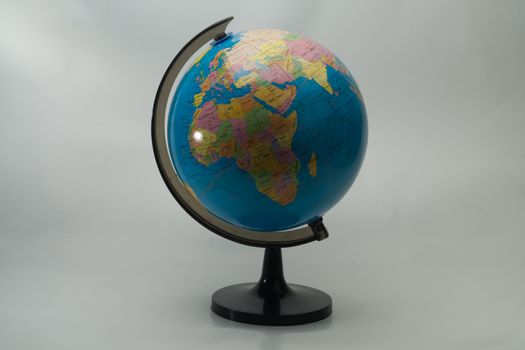 Modeled globes are used as teaching aids in the education of the classroom. White background.