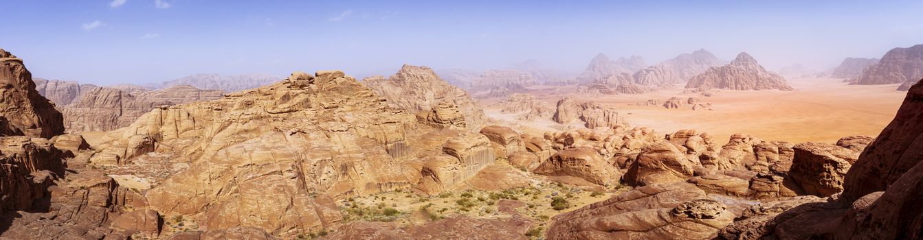 Vivid and colorful panorama of the Wadi Rum desert in Jordan as seen from Burdah Rock Mountain. Travel and tourism in Jordan