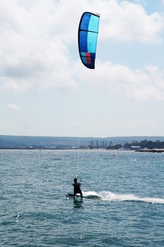 Varna, Bulgaria - July, 19, 2020: a man is kiting the sea against the background of the beach