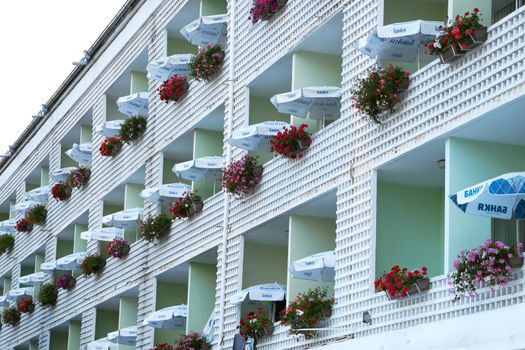 Varna, Bulgaria - June, 19, 2020: flowers and umbrellas on the balconies of the hotel, the facade in perspective