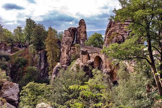 Bastei, view of the Bastei bridge and stone gate. Bastei is famous for the beautiful rock formation in the Saxon Switzerland National Park near Dresden. Popular travel destination in Saxony.



