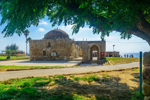 Achziv, Israel - July 22, 2020: View of an old mosque building, with visitors, in Achziv national park, northern Israel