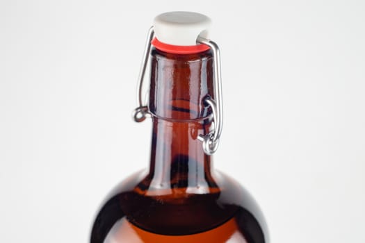 brown bottle swing top or flip-top close-up with selective focus.