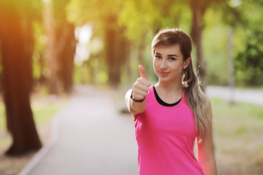 The young woman is engaged in sports fitness in nature forest Healthy fit living. Motivation healthy fit living. Running shoe. Beautiful sunlight. Woman warming up before running