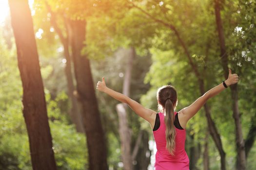 The young woman is engaged in sports fitness in nature forest Healthy fit living. Motivation healthy fit living. Running shoe. Beautiful sunlight. Woman warming up before running