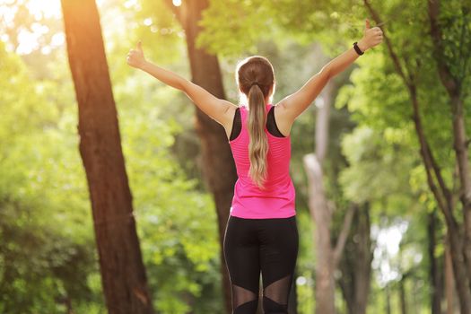 The young woman is engaged in sports fitness in nature forest Healthy fit living. Motivation healthy fit living. Running shoe. Beautiful sunlight. Woman warming up before running