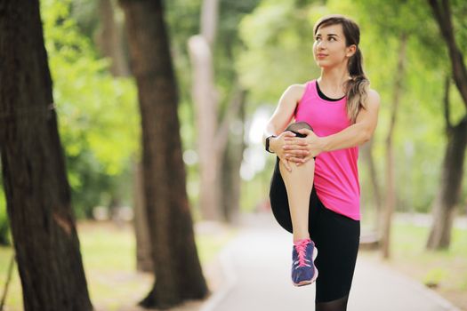 The young woman is engaged in sports fitness in nature forest Healthy fit living. Motivation healthy fit living. Running shoe. Beautiful sunlight. Woman warming up before running