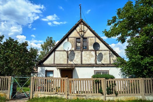 Historic country house with satellite TV antennas in Poland