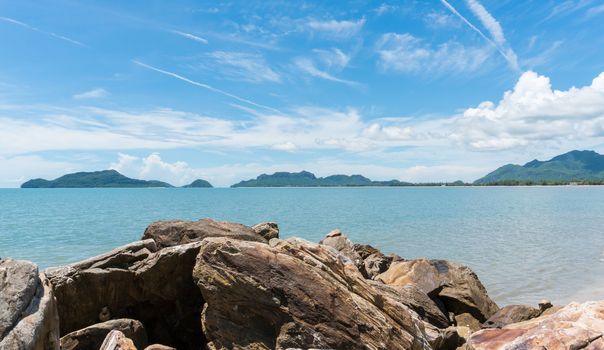 Scenery or landscape of the beach at Prachuap Khiri Khan Thailand. Sea or brine and rock or stone and blue sky and green tree mountain. 
Summer concept in relaxation mood for design