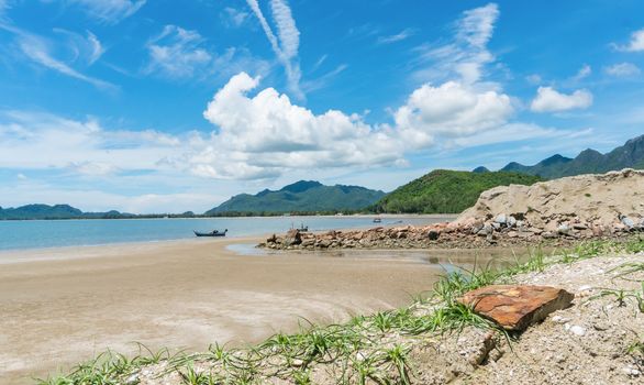 Fishing Boat on beach and green tree mountain and blue sky and sea and rock or stone at Prachuap Khiri Khan Thailand. Summer concept in 
relaxation mood for design