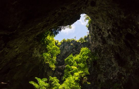 Sun light hole in Phraya Nakhon Cave with green tree and blue sky and cloud at Prachuap Khiri Khan Thailand. Natural cave in unseen Thailand