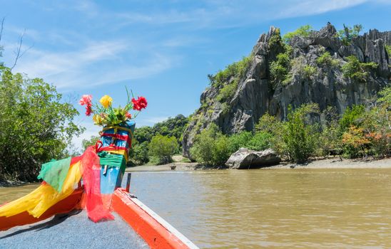 Khao Dang canal boat trip at Prachuap Khiri Khan Thailand. Boat or fishing boat and rock or stone mountain or hill with blue sky and cloud and green tree and water. Landscape or scenery summer concept for boat trip