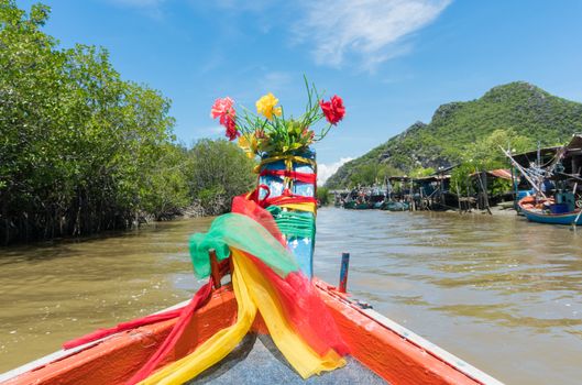 Fishing village and fishing boat at Khao Dang village. Old home and fishing boat and blue sky and cloud and water and green tree. Landscape or scenery summer concept for boat trip